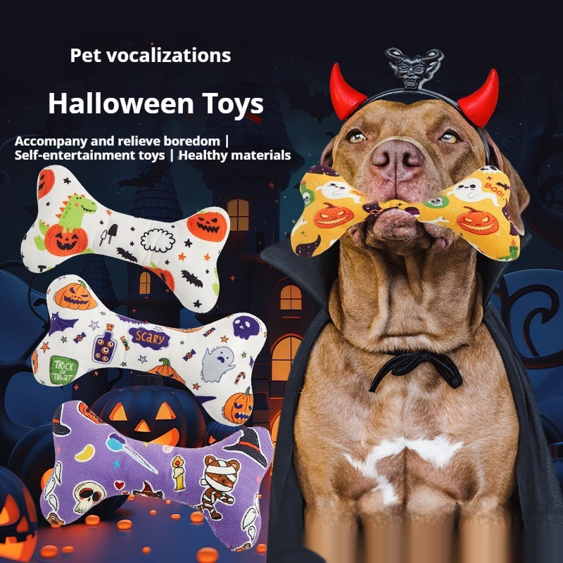 Dog wearing devil horns holding two Halloween plush squeaky bone toys