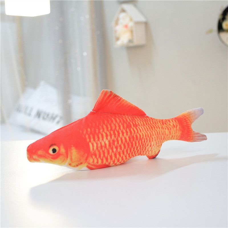 Red carp plush fish cat toy on a white table