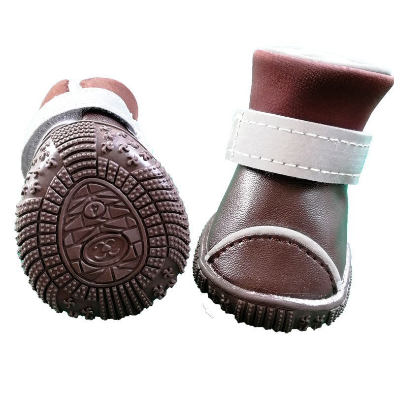 Two brown dog boots, one turned to show the textured rubber sole