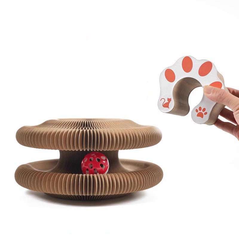 Accordion scratcher opened flat with the red bell ball in its track, next to a paw-print panel